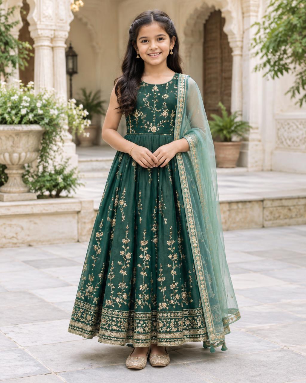 Girl in an emerald and gold festive dress